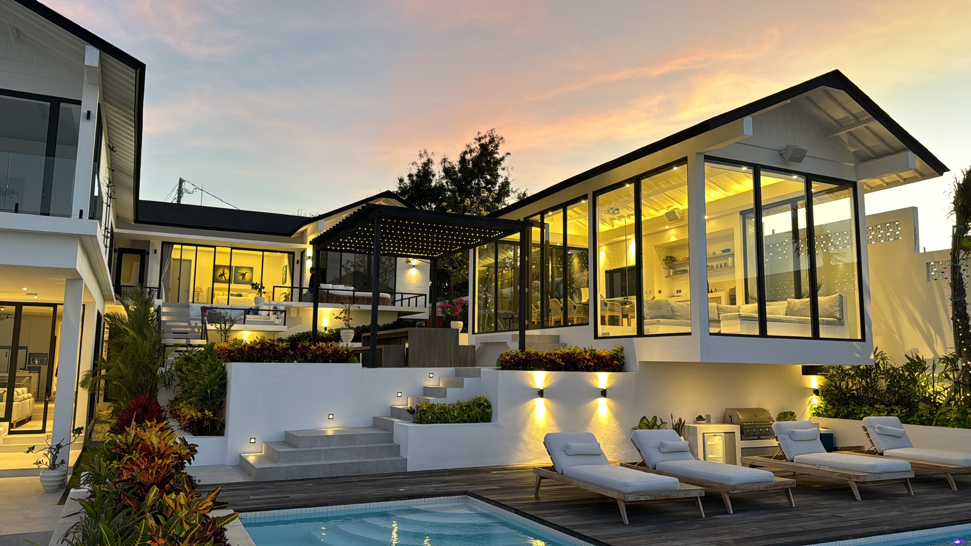 Warmly lit villa surrounded by a landscaped garden